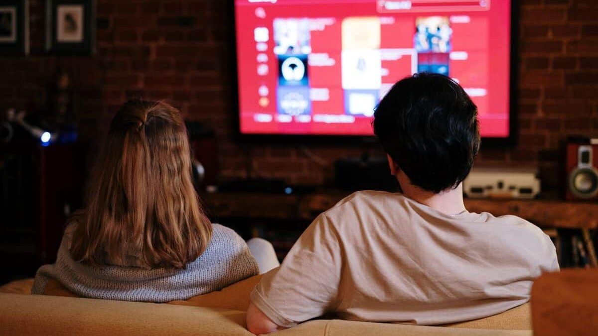 Couple watching a TV streaming service like Amazon Prime or Netflix.
